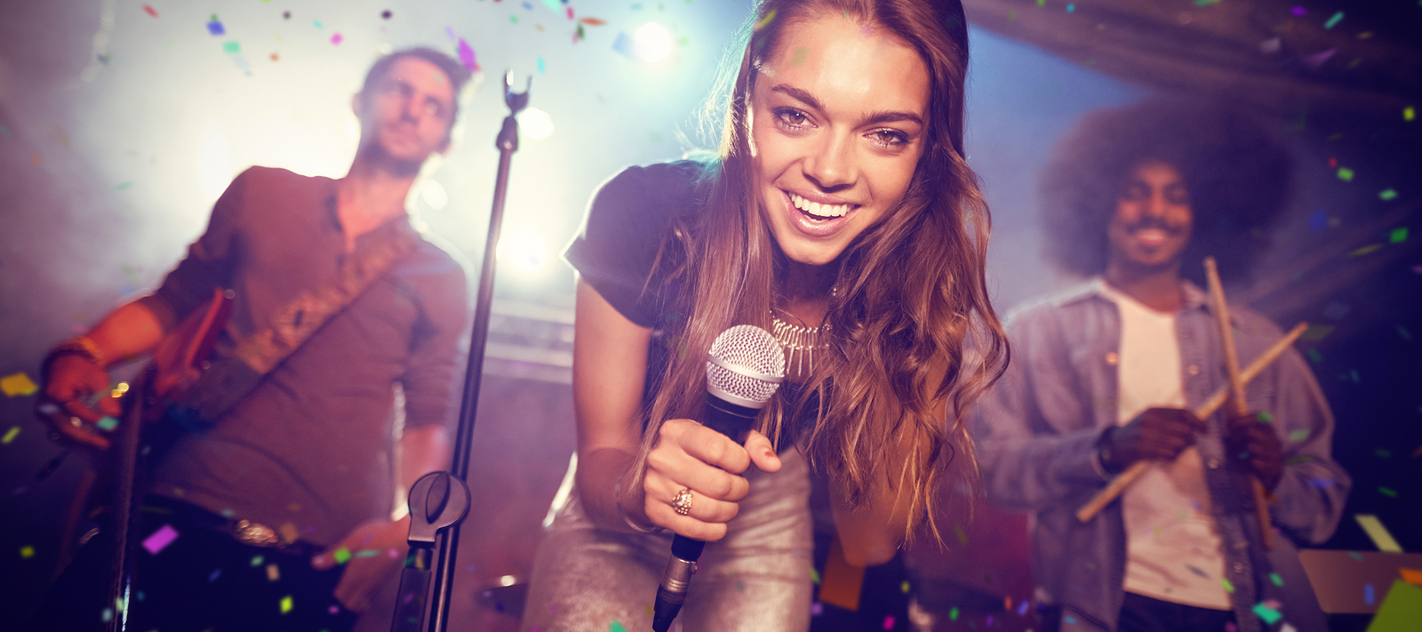 flying-colors-against-portrait-of-singer-with-musicians-on-stage