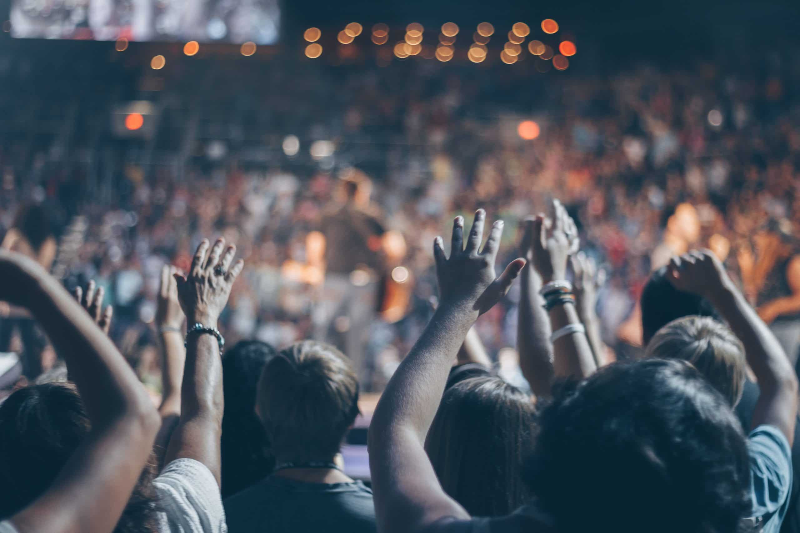 group-of-people-raise-their-hands-on-stadium-976866-scaled-1